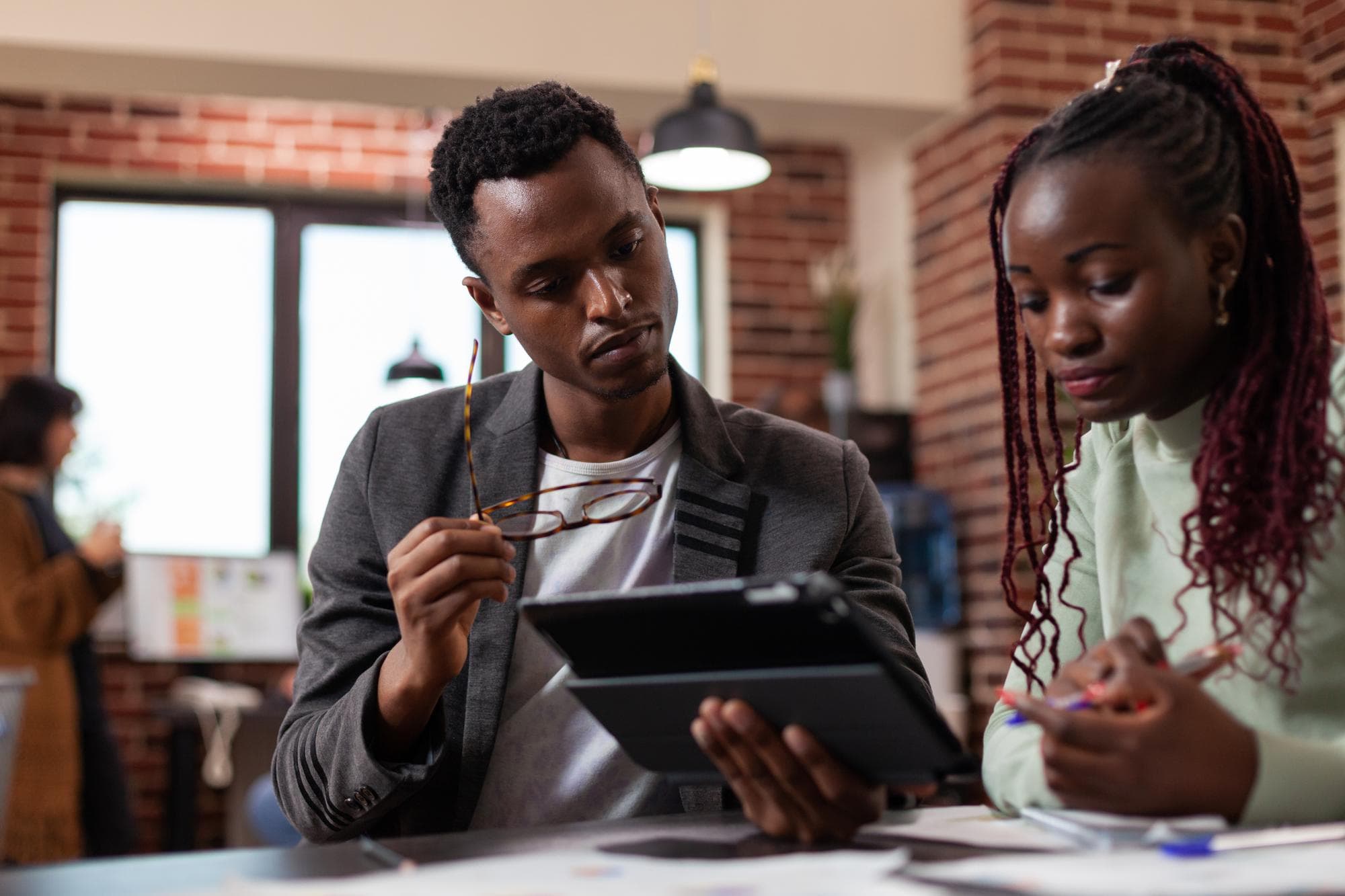 Founders collaborating over a tablet