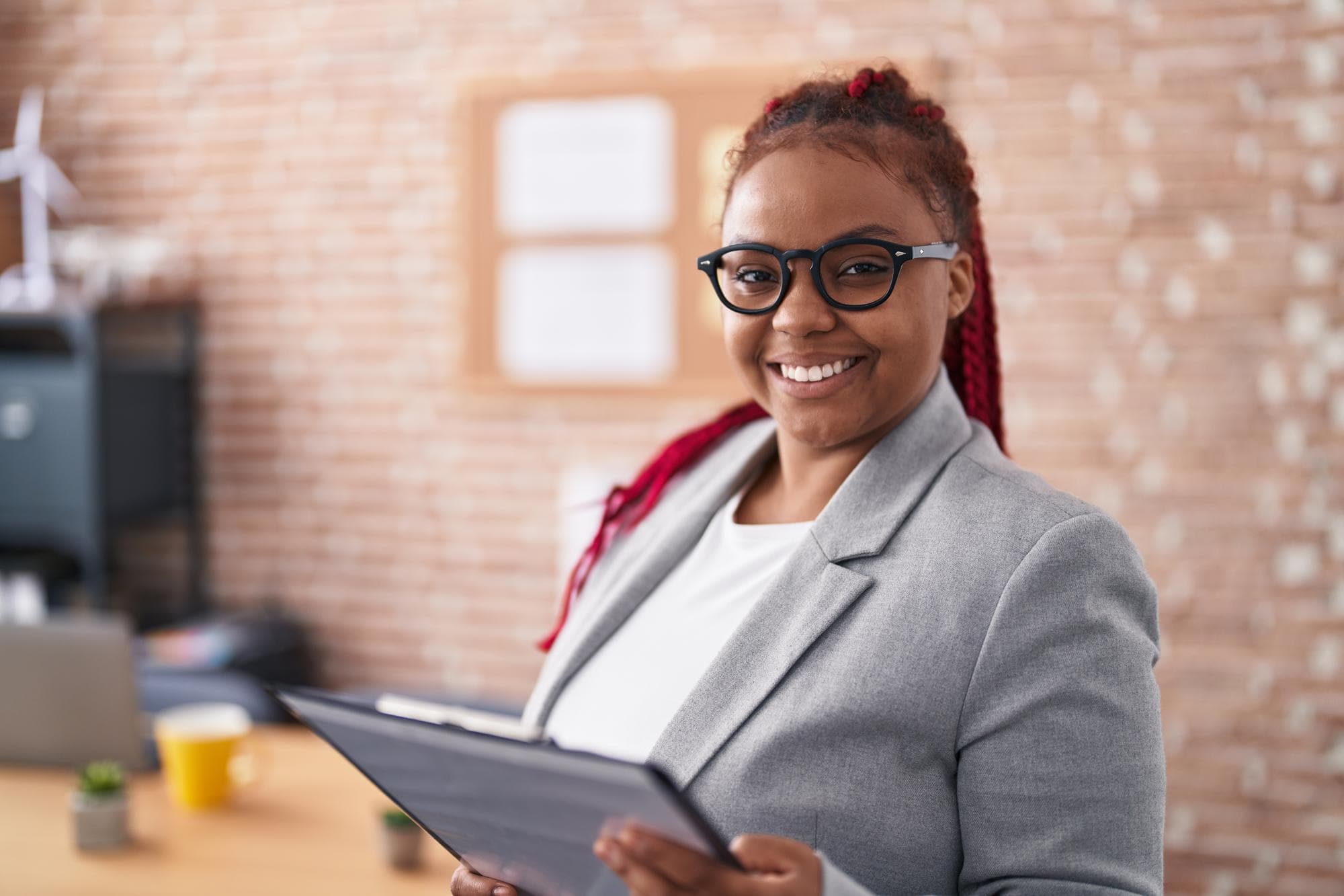 Professional holding a folder in an office
